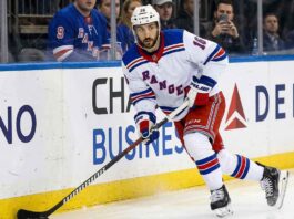 New York Rangers forward Vincent Trocheck (16) handles the puck during an NHL game, seen here amidst offseason NHL trade rumors.