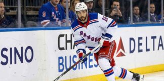 New York Rangers forward Vincent Trocheck (16) handles the puck during an NHL game, seen here amidst offseason NHL trade rumors.