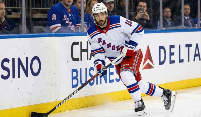 New York Rangers forward Vincent Trocheck (16) handles the puck during an NHL game, seen here amidst offseason NHL trade rumors.