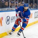 New York Rangers center Vincent Trocheck #16 skating with the puck on home ice amid NHL trade rumors.