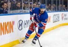 New York Rangers center Vincent Trocheck #16 skating with the puck on home ice amid NHL trade rumors.