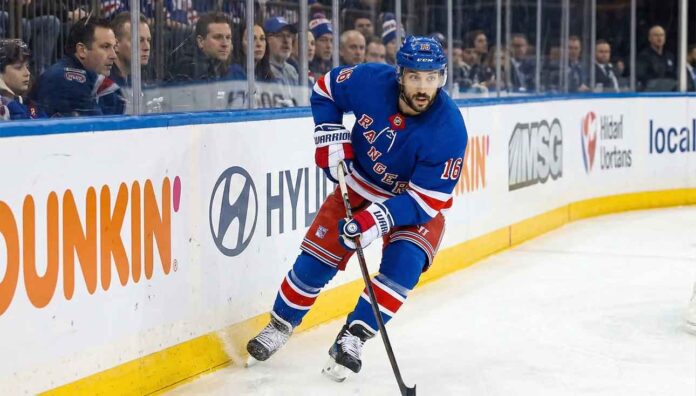 New York Rangers center Vincent Trocheck #16 skating with the puck on home ice amid NHL trade rumors.