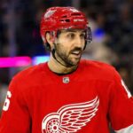 The Trade Package the New York Rangers Want for Vincent Trocheck Photo illustration showing New York Rangers center Vincent Trocheck wearing a Detroit Red Wings jersey on the ice amid recent NHL trade rumors linking him to the team.
