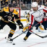 Washington Capitals' Alex Ovechkin battles for the puck with Boston Bruins' Charlie McAvoy during today's NHL game.