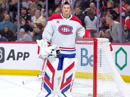 Will the Montreal Canadiens Trade Sam Montembeault This Offseason? Montreal Canadiens goaltender Sam Montembeault, in full gear with his team's red, white, and blue jersey, standing by his net during an NHL game, amid swirling trade rumors and discussions about his offseason future.