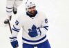 Concept mockup of pending unrestricted free agent Alex Tuch wearing a white Toronto Maple Leafs away jersey and white helmet on the ice.