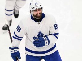 Concept mockup of pending unrestricted free agent Alex Tuch wearing a white Toronto Maple Leafs away jersey and white helmet on the ice.