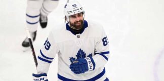 Concept mockup of pending unrestricted free agent Alex Tuch wearing a white Toronto Maple Leafs away jersey and white helmet on the ice.