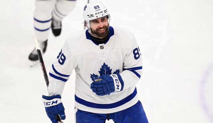 Concept mockup of pending unrestricted free agent Alex Tuch wearing a white Toronto Maple Leafs away jersey and white helmet on the ice.