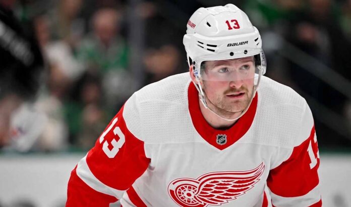 A conceptual photo visualization of current New York Rangers forward Alexis Lafreniere wearing a Detroit Red Wings away jersey, illustrating a potential offseason NHL trade scenario discussed in this post.