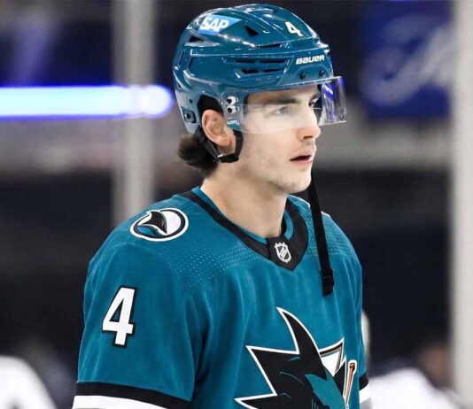New York Rangers defenseman Braden Schneider pictured in a teal San Jose Sharks uniform, visualizing NHL trade rumors amid NYR rebuild.
