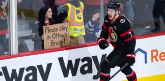 Ottawa Senators captain Brady Tkachuk on the ice wearing the away white jersey amidst NHL trade rumors.