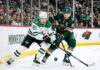 Dallas Stars' Jason Robertson #21 battles Minnesota Wild's Kirill Kaprizov #97 for a loose puck in a tightly contested corner during Game 6 of the 2026 NHL Stanley Cup Playoffs at Xcel Energy Center. The high-resolution photo captures the intensity and focus of two star players in a defining moment of the series.