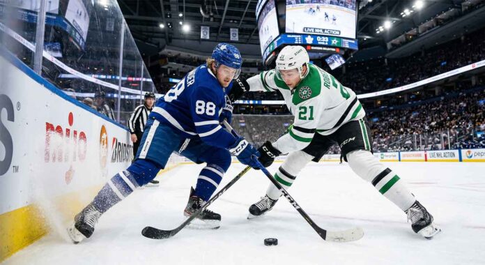 Toronto Maple Leafs forward William Nylander (left) and Dallas Stars forward Jason Robertson (right) clash along the boards in a battle for the puck during their NHL matchup.