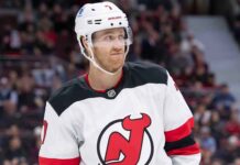 New Jersey Devils defenseman Dougie Hamilton looks to make a play, amid NHL trade rumors linking him to the Detroit Red Wings and Utah Mammoth.