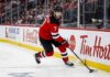 New Jersey Devils defenseman Dougie Hamilton skating with the puck during an NHL game amid offseason trade rumors