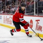 New Jersey Devils defenseman Dougie Hamilton skating with the puck during an NHL game amid offseason trade rumors
