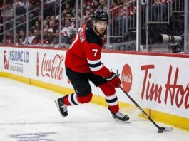 New Jersey Devils defenseman Dougie Hamilton skating with the puck during an NHL game amid offseason trade rumors