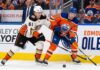Anaheim Ducks vs Edmonton Oilers playoff action showing Cutter Gauthier battling Connor McDavid for the puck during 2026 Stanley Cup Playoffs Game 5.