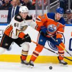 Anaheim Ducks vs Edmonton Oilers playoff action showing Cutter Gauthier battling Connor McDavid for the puck during 2026 Stanley Cup Playoffs Game 5.