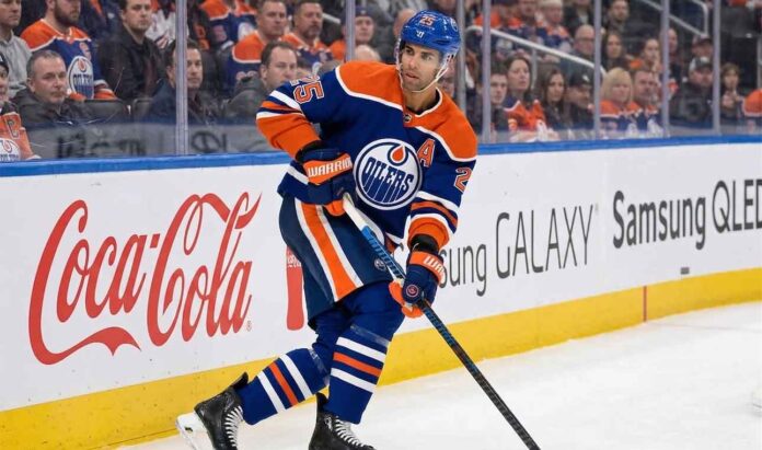 Edmonton Oilers defenseman Darnell Nurse (#25) skating with the puck on the ice during an NHL hockey game.