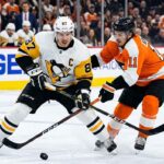 Intense puck battle between Pittsburgh Penguins captain Sidney Crosby (#87) and Philadelphia Flyers forward Travis Konecny (#11) during an NHL Stanley Cup Playoff game.