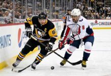 How to Watch Pittsburgh Penguins at Washington Capitals | TV Channels & Stream Sidney Crosby of the Pittsburgh Penguins battles Alex Ovechkin of the Washington Capitals for the puck during their April 11, 2026 NHL game.