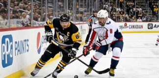 Sidney Crosby of the Pittsburgh Penguins battles Alex Ovechkin of the Washington Capitals for the puck during their April 11, 2026 NHL game.