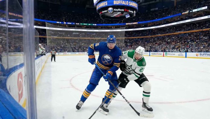 how-to-watch-stars-vs-sabres-april-15-2026 Buffalo Sabres defenseman Rasmus Dahlin (26) in blue battles Dallas Stars forward Jason Robertson (21) in white for the puck during an NHL game at KeyBank Center.