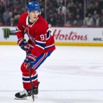 Montreal Canadiens forward Ivan Demidov skates on the ice in a home red jersey.