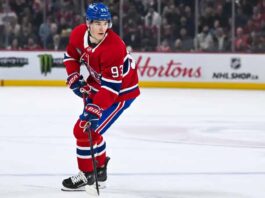 Montreal Canadiens forward Ivan Demidov skates on the ice in a home red jersey.