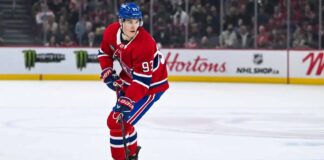 Montreal Canadiens forward Ivan Demidov skates on the ice in a home red jersey.