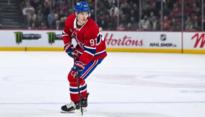 Montreal Canadiens forward Ivan Demidov skates on the ice in a home red jersey.