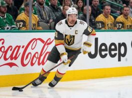 Will Mark Stone Retire? Vegas Golden Knights Injury Updates & Cap Impact Vegas Golden Knights captain Mark Stone in white jersey skating with the puck during an NHL game, amid speculation regarding his injury history and potential retirement.