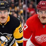 A close-up portrait of hockey player Mason Marchment with intense blue eyes and a mustache, wearing a white Seattle Kraken jersey, who is currently a pending UFA for the Columbus Blue Jackets and a target for the Pittsburgh Penguins and Detroit Red Wings in NHL free agency.