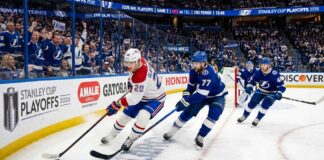 Montreal Canadiens forward Juraj Slafkovsky (#20) carrying the puck against Tampa Bay Lightning defenseman Victor Hedman (#77) during Game 2 of the 2026 NHL Playoffs.