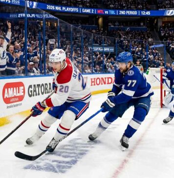 Montreal Canadiens forward Juraj Slafkovsky (#20) carrying the puck against Tampa Bay Lightning defenseman Victor Hedman (#77) during Game 2 of the 2026 NHL Playoffs.