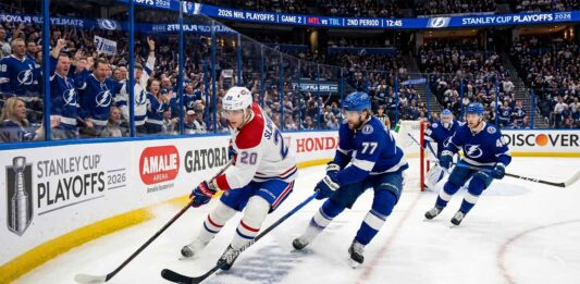 Montreal Canadiens forward Juraj Slafkovsky (#20) carrying the puck against Tampa Bay Lightning defenseman Victor Hedman (#77) during Game 2 of the 2026 NHL Playoffs.