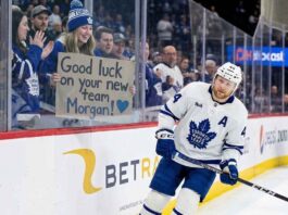 Toronto Maple Leafs Trade Rumors: Moving Morgan Rielly Toronto Maple Leafs defenseman Morgan Rielly skates past a young fan holding a cardboard sign that reads "Good luck on your new team Morgan!" amid persistent trade rumors.