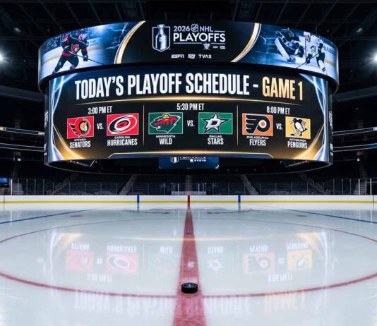 Jumbotron over center ice in an empty hockey arena, displaying the game schedule and team matchups for the first day of the 2026 NHL Playoffs, a critical piece of NHL news.