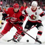 Carolina Hurricanes Sebastian Aho and Ottawa Senators Brady Tkachuk battling for the puck during Game 1 of the 2026 NHL Playoffs.