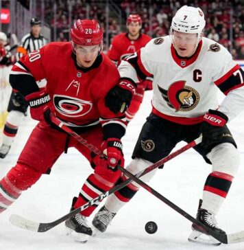 Carolina Hurricanes Sebastian Aho and Ottawa Senators Brady Tkachuk battling for the puck during Game 1 of the 2026 NHL Playoffs.