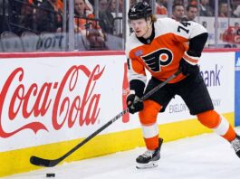 A photo of Philadelphia Flyers forward Owen Tippett (74) in action, skating and controlling the puck on the ice during an NHL game, used to analyze his performance and trade status.