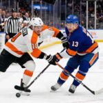 Philadelphia Flyers Travis Konecny (11) and New York Islanders Mathew Barzal (13) in a fierce battle for the hockey puck during a Metropolitan Division NHL game at UBS Arena.