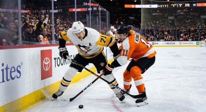 Pittsburgh Penguins center Evgeni Malkin (71) battles Philadelphia Flyers forward Travis Konecny (11) along the boards for puck possession during an intense NHL playoff game in the Battle of Pennsylvania rivalry.