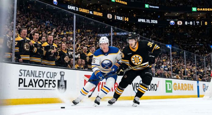 sabres-vs-bruins-game-3-playoff-action-2026 A dynamic photo of Buffalo Sabres and Boston Bruins players battling on the ice during Game 3 of the Stanley Cup Playoffs at TD Garden on April 23, 2026.