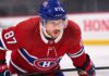 Realistic photo rendering of hockey player Sidney Crosby wearing a red Montreal Canadiens jersey with the captain’s ‘C’ patch, illustrating NHL trade rumors between the Pittsburgh Penguins and Canadiens.