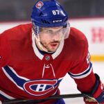 Realistic photo rendering of hockey player Sidney Crosby wearing a red Montreal Canadiens jersey with the captain’s ‘C’ patch, illustrating NHL trade rumors between the Pittsburgh Penguins and Canadiens.