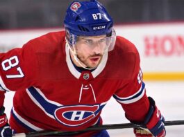 Realistic photo rendering of hockey player Sidney Crosby wearing a red Montreal Canadiens jersey with the captain’s ‘C’ patch, illustrating NHL trade rumors between the Pittsburgh Penguins and Canadiens.
