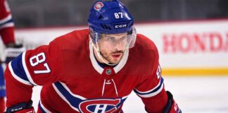 Realistic photo rendering of hockey player Sidney Crosby wearing a red Montreal Canadiens jersey with the captain’s ‘C’ patch, illustrating NHL trade rumors between the Pittsburgh Penguins and Canadiens.
